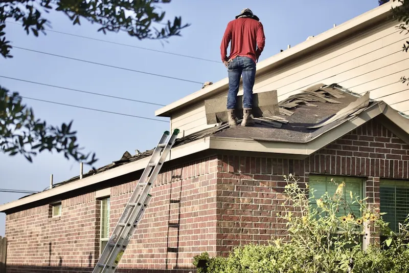 Professional roofer working on a residential roof in Utopia